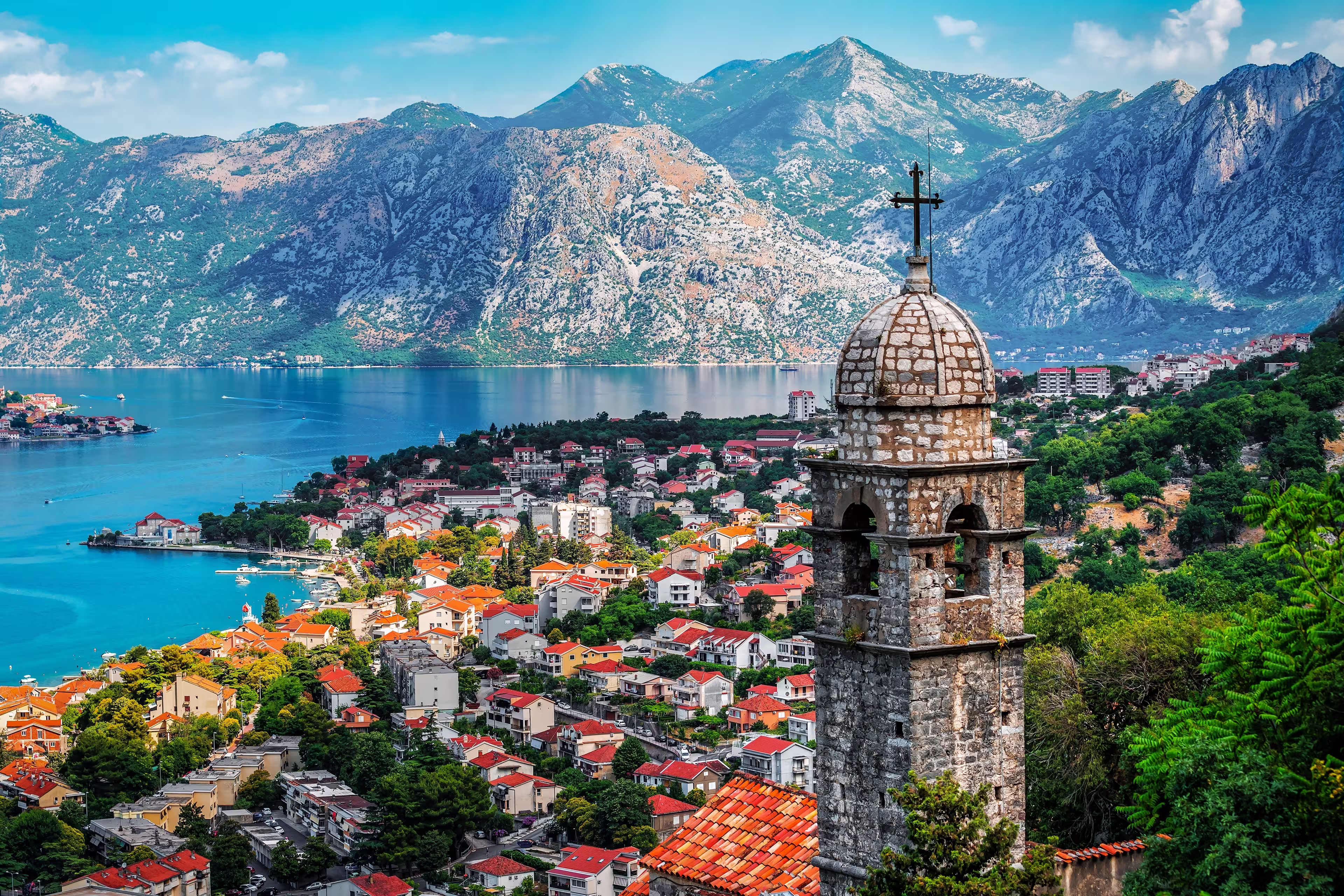 Bell tower of Church Our Lady of Remedy on the hill tower in the old city of Kotor and the Kotor Bay in Montenegro. Travel and vacation theme