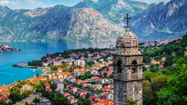 Bell tower of Church Our Lady of Remedy on the hill tower in the old city of Kotor and the Kotor Bay in Montenegro. Travel and vacation theme