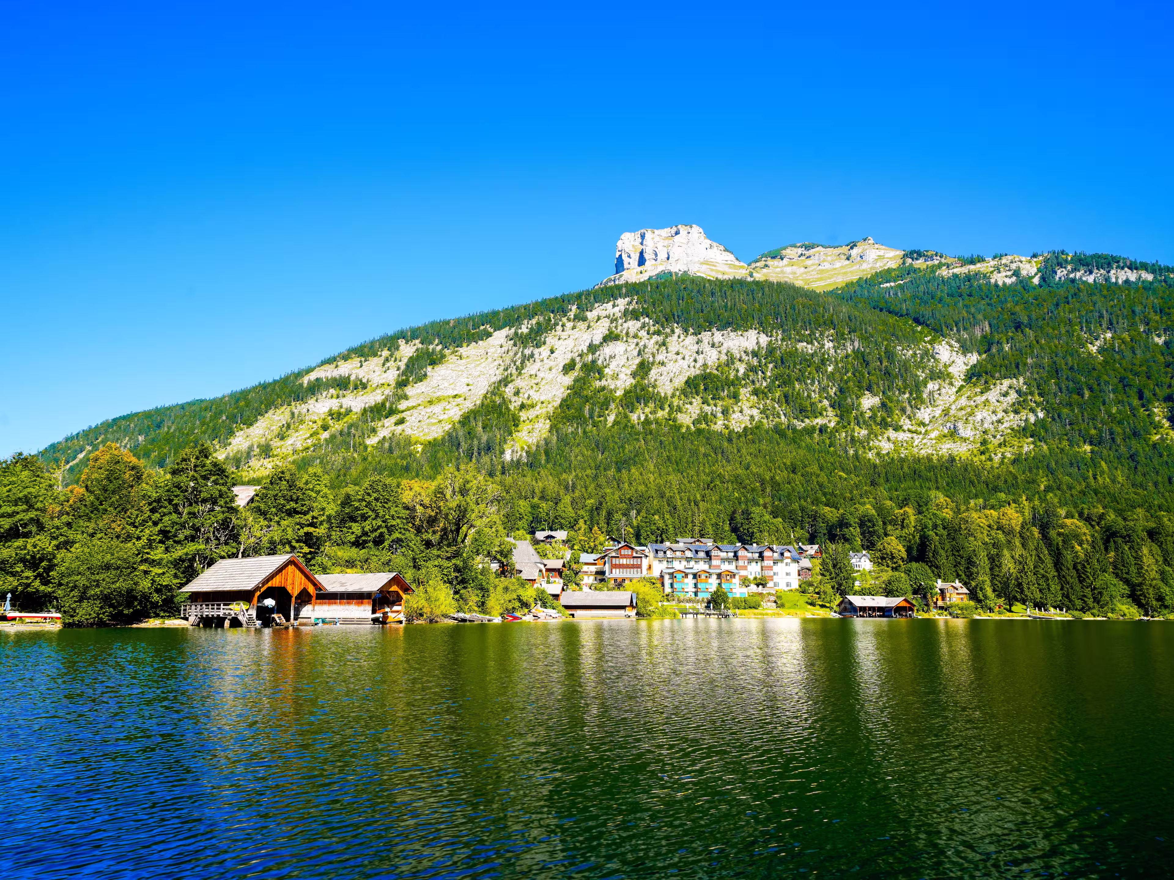 Landscape at Lake Altaussee in the Salzkammergut in Austria. Idyllic nature by the lake in Styria. Altaussee at Totes Gebirge with a view of the surrounding mountains.