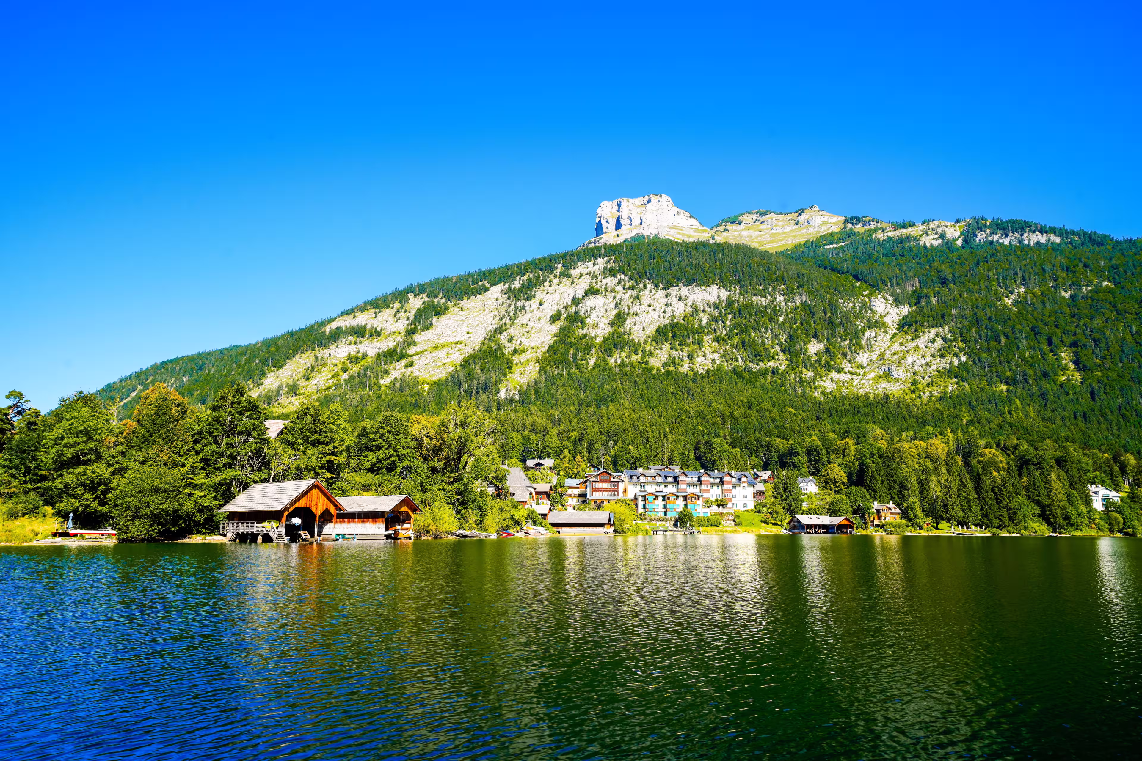 Landscape at Lake Altaussee in the Salzkammergut in Austria. Idyllic nature by the lake in Styria. Altaussee at Totes Gebirge with a view of the surrounding mountains.